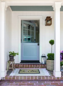 a blue dutch door at the entry of a home