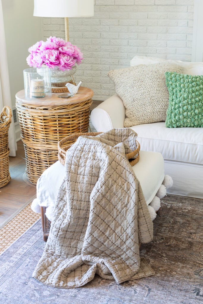 Early spring decor in living room using faux pink peonies and light green accent