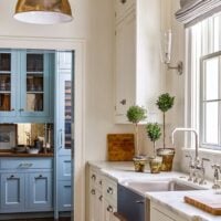creamy white cabinet kitchen with a blue cabinet butler's pantry