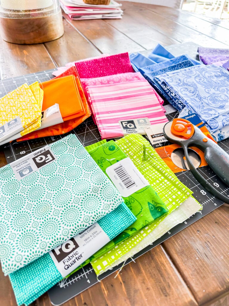 Pile of Fabric scraps and quilt fabric quarters