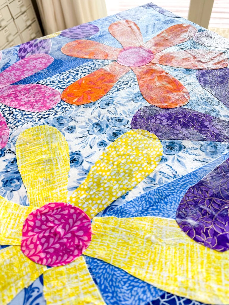 Attaching cut-out fabric flowers to canvas