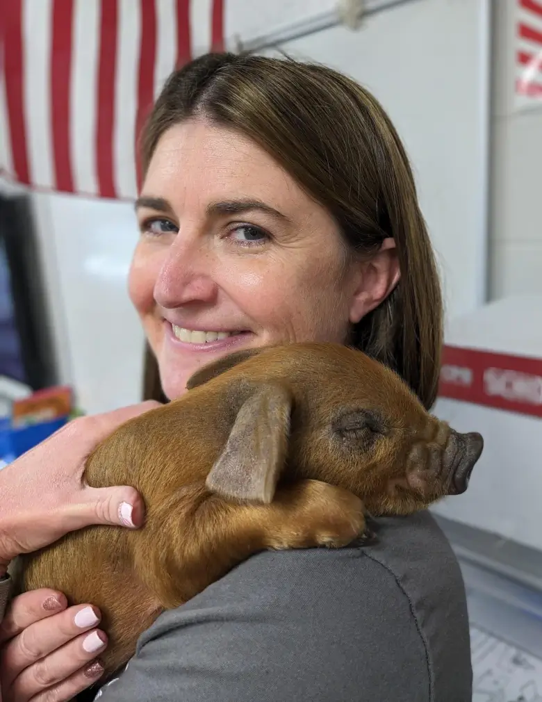 Holly holding a piglet