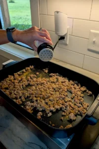 Seasoning the meat for shepherd's pie