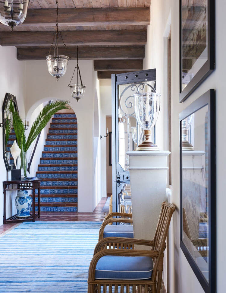Entry room with blue steps leading to a second floor