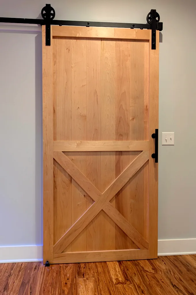 Maple wood barn door with black hardware
