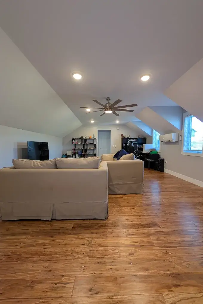 Large room with couches and shelves