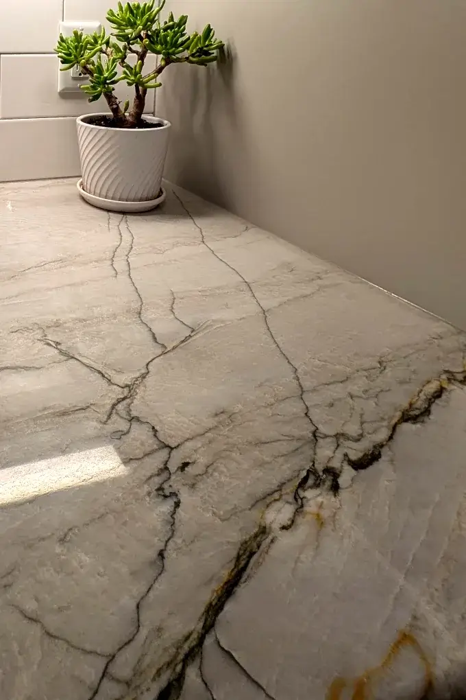 Close up image of quartzite countertops with streaks of gray and copper