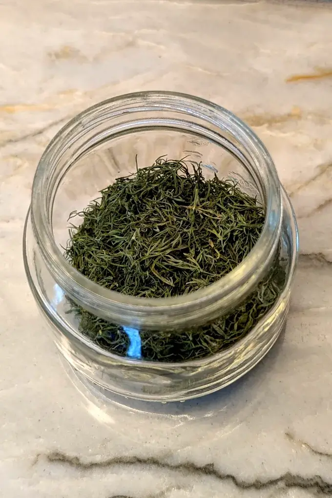 Dried dill weed in a small glass jar