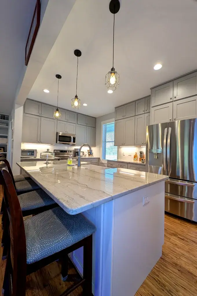 Kitchen with white and gray cabinets and stainless steel appliances