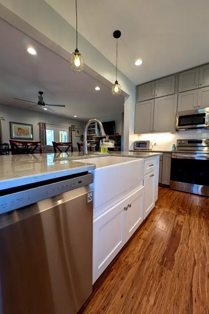 White farmhouse style sink with white cabinets