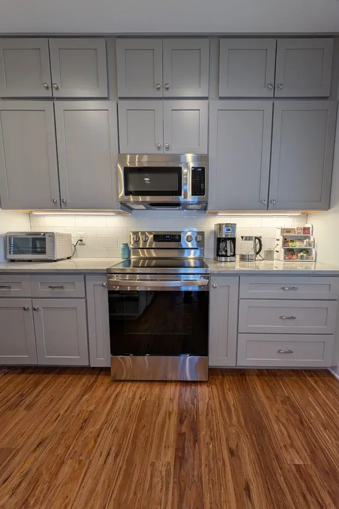 Gray cabinets that extend from the floor to the ceiling