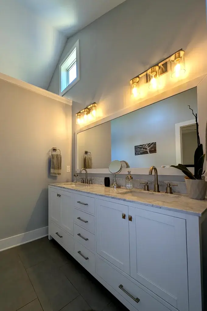 Bathroom vanity with two sinks and a large mirror