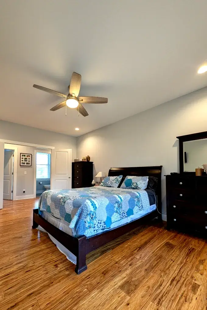 Bedroom with a bed, bedroom furniture, and a ceiling fan
