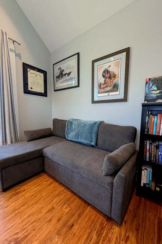Office area with a couch and artwork on the wall