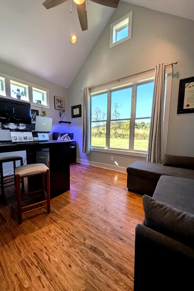 Home office with a large desk and a couch